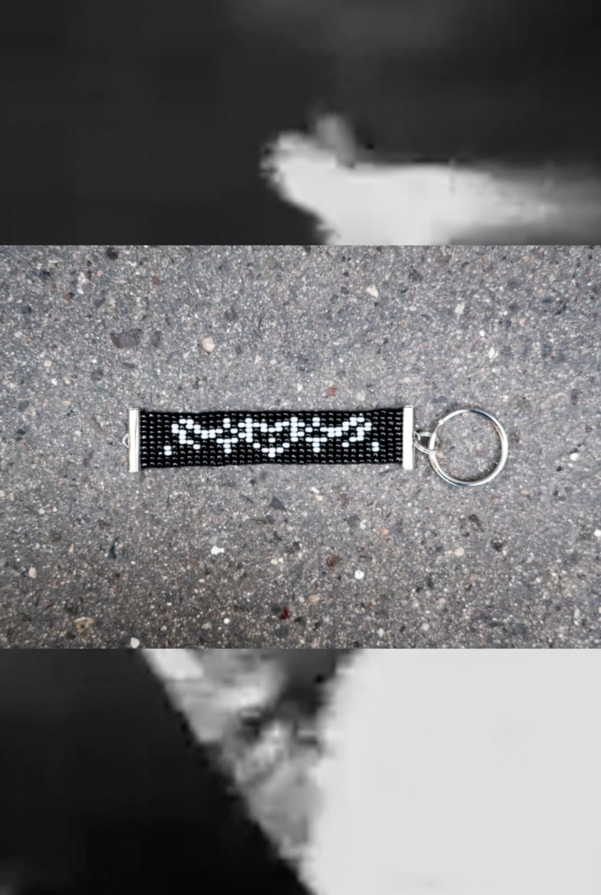 Black beaded keyring with white ACAB lettering